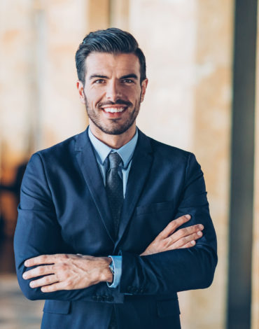 Businessman with arms crossed looking at camera